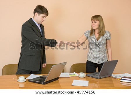 Handshake men and young women in the office