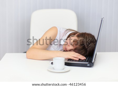The woman was tired and fell asleep at the table with a laptop