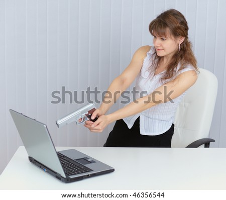 The woman calmly fired a pistol at a computer screen