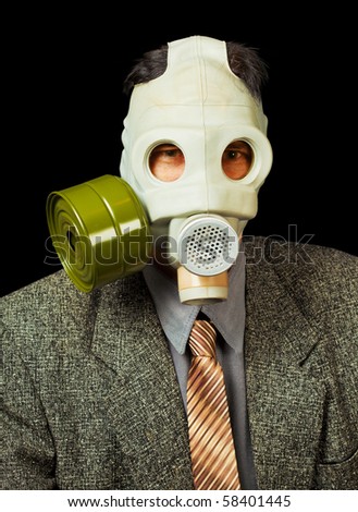 Portrait of the person in a gas mask on a black background