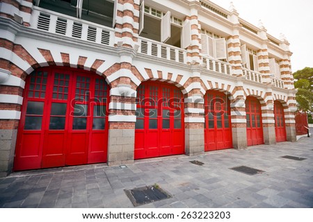 Attractive, accented brickwork facade and bright red painted garage doors of a fire station in singapore.