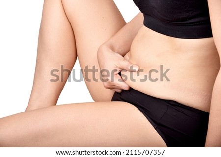Fat woman holding excessive belly fat, Overweight woman check out her obesity, Woman muffin top waistline. Photo stock © 
