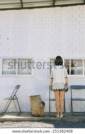 Girl and white brick wall. Minimal Space, Vintage Style. (Soft Light Process)