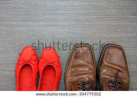 Shoes of a man and a woman on the floor. Red Shoe. Man and Women accessories.