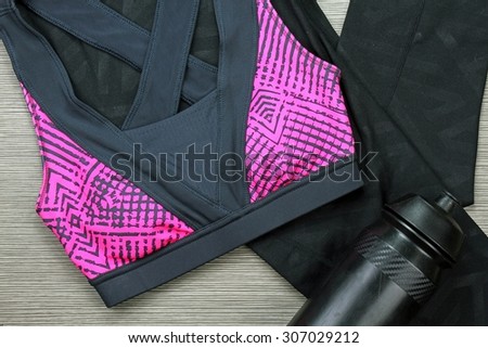 Women\'s sports bra and Black Bicycle water bottle. Sport wear, Sport fashion, Sport accessories, Sport equipment.