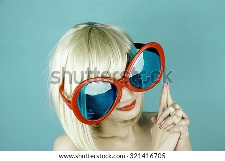Funny girl with funny glasses, Happy naughty blonde hair woman with giant sunglasses. Woman in crazy clown glasses, Large funny glasses. (Vintage Style Color)