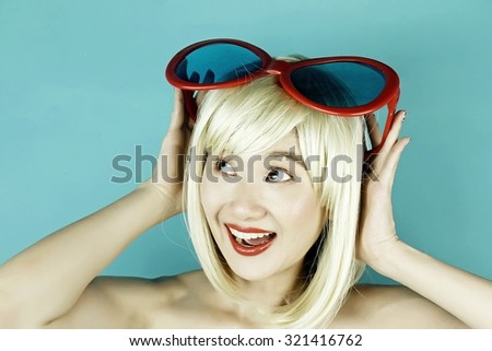Funny girl with funny glasses, Happy naughty blonde hair woman with giant sunglasses. Woman in crazy clown glasses, Large funny glasses. Curious.(Vintage Style Color)