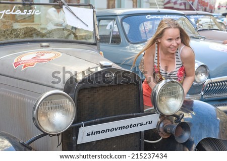 MOSCOW, RUSSIA - July 26, 2014: Soviet retro car GAZ-a and girl retro rally Gorkyclassic in the Parking lot near Gum Department store, Moscow, front view
