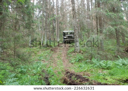 CHERNOGOLOVKA, MOSCOW REGION, RUSSIA-JUNE 21, 2013: American retro car Dodge WC-51 rides in the forest on the hard road, 3rd international meeting \