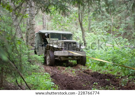 CHERNOGOLOVKA,MOSCOW REGION,RUSSIA-JUNE 21,2013: Old military retro car Dodge WC-51 stuck in the woods on a heavy road, 3rd international meeting \