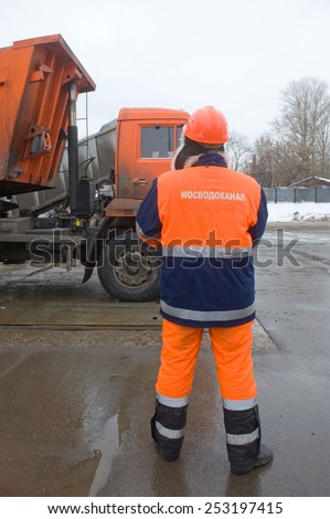 MOSCOW, RUSSIA - February 13, 2015: Employee Mosvodokanal monitors the discharge of snow from the truck, snow melting point Moscow