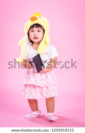 Asian Baby Girl Sitting On The Floor Isolated On White Backgrounds