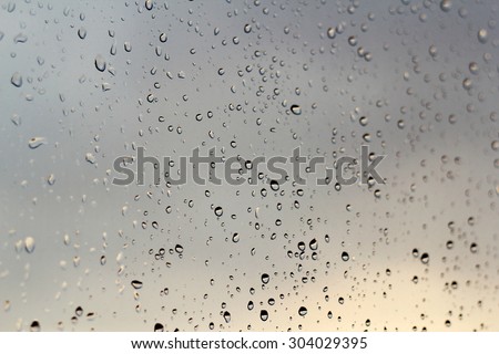 Rain drops on the window / sunset behind - abstract color background