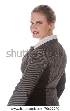 Young woman with lip piercing in a gray business suit and high heels, isolated on a white background