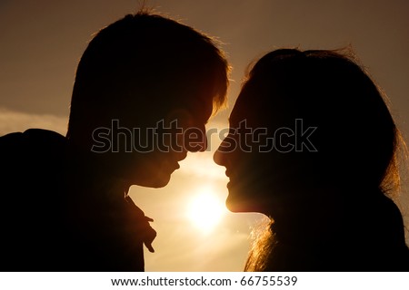 Love couple in warm color sunset. silhouette