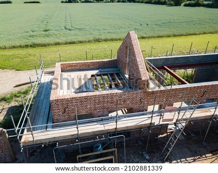 Up close aerial drone view of a barn conversation showing scaffolding and brickwork Foto stock © 