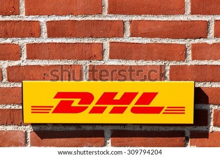 Aarhus, Denmark - August 22, 2015: DHL logo on a facade.\
DHL Express is a division of the german logistics company Deutsche Post DHL providing international express mail services.