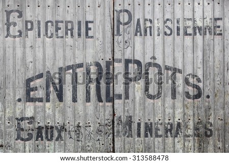 Belleville sur Saone, France - February 2, 2015: Old and vintage door with drinks advertising in France
