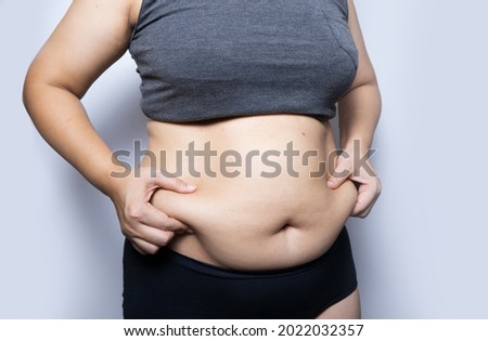 woman squeezing his fat belly. Photo stock © 
