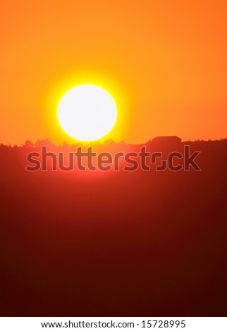 Closeup of rising sun with copyspace. Can be used as concept for global warming, new day, solar energy etc.