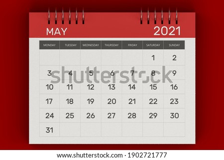 3d rendering of Business monthly calendar with metal spiral-bound, the week starts on Monday. Monthly Pages with red title, isolated on red background. English calendar for May 2021 Foto d'archivio © 