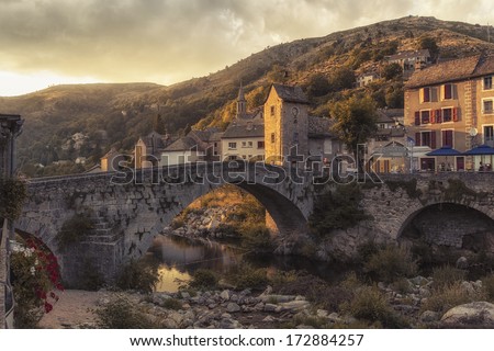 Summer sunset view of a old bridge in a typical French Village