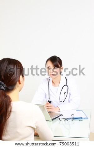 young Japanese female doctor talks to her patient