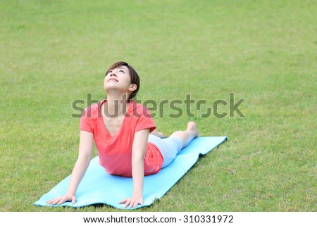Japanese woman doing yoga Cobra Pose