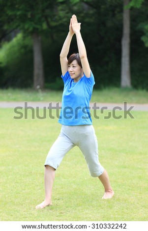 Japanese woman doing yoga warrior I pose
