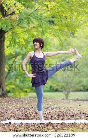 Japanese Woman Doing YOGA Extended Hand-To-Big-Toe Pose