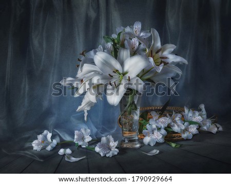Still life with white lilies on a dark background.