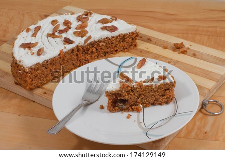 Slice of carrot cake on a desert plate with cake fork