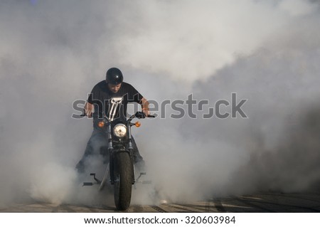 WARSAW - AUGUST 29: Biker burning tire and creating smoke. American Day in Warsaw on August 29, 2015 in Poland