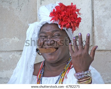 Cuban woman smoking cigar on streets year 2006