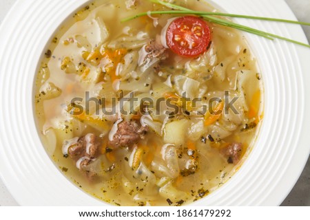 Traditional Russian Cabbage Soup Schi On White Plate. Flat Lay. Close Up. Imagine de stoc © 