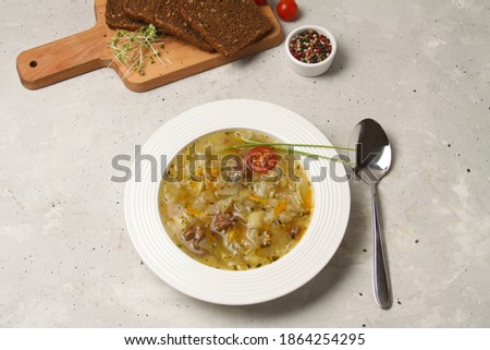 Traditional Russian Cabbage Soup Schi On White Plate With Spoon, Sliced Rye Black Bread On Wooden Board Grey Background. Imagine de stoc © 