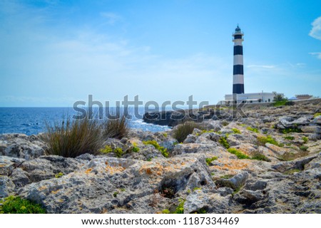 Minorca Lighthouse Cap de Artrutx cala n'bosch. Cami de cavalls. Beautiful coastal landscape with black and white lighthouse in the background and marine flora in the foreground Foto stock © 