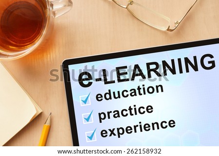 Tablet with words e-learning. Business concept.