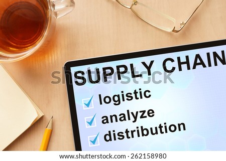 Tablet with words  supply chain management . Business concept.