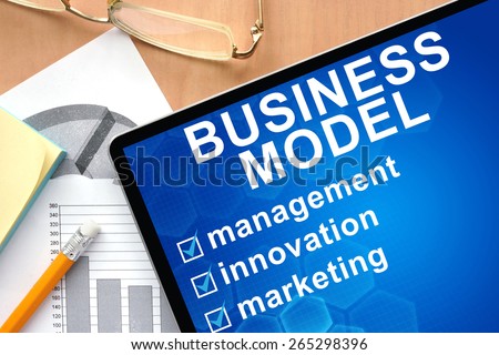 Tablet with words business model. Business and management concept.