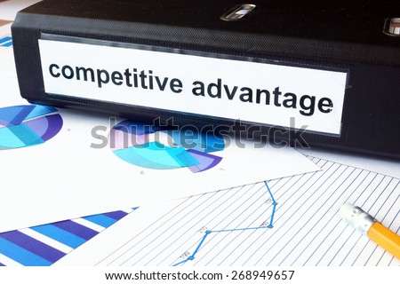 Graphs and file folder with label competitive advantage. Business concept.