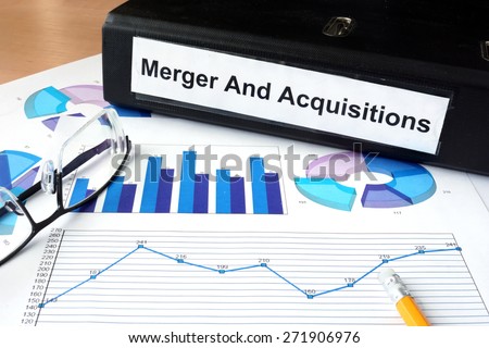 File folder with Merger and Acquisition and financial graphs. Business concept