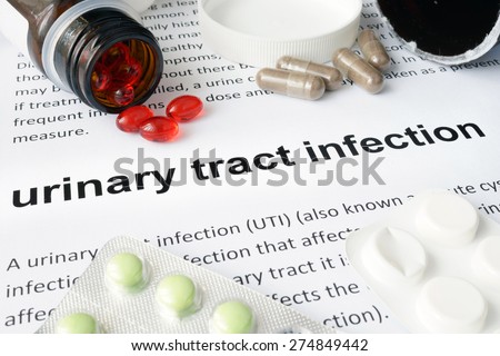 Paper with urinary tract infection and pills. Medical concept.