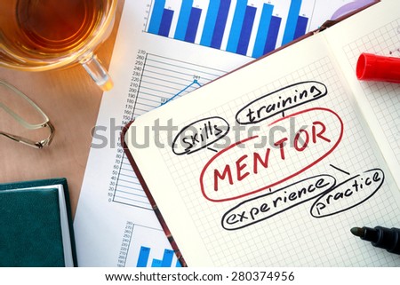 Notepad with word mentor concept and marker.