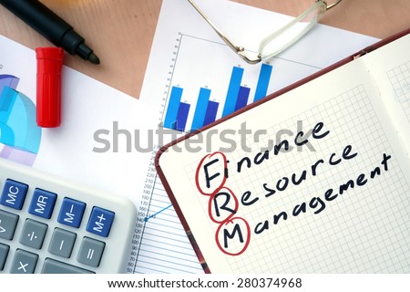 Notepad with words FRM finance resource management  concept and marker.