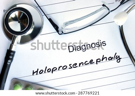 Form with diagnosis Holoprosencephaly and tablets. Medical concept.