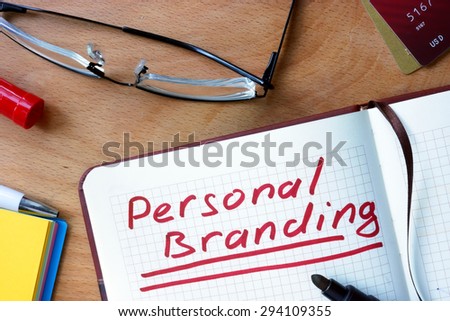 Notepad with Personal Branding on office wooden table.