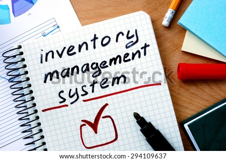 Notepad with inventory management system on office wooden table.
