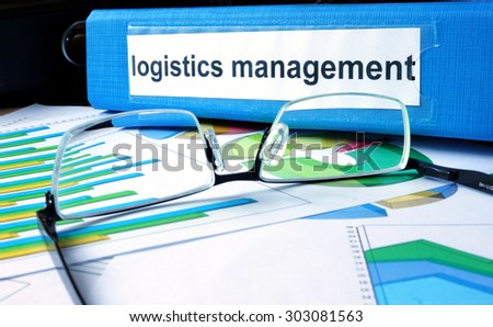 Folder with label logistics management on the office table.