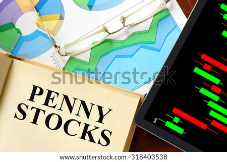Words penny stocks  written on a book. Business concept.